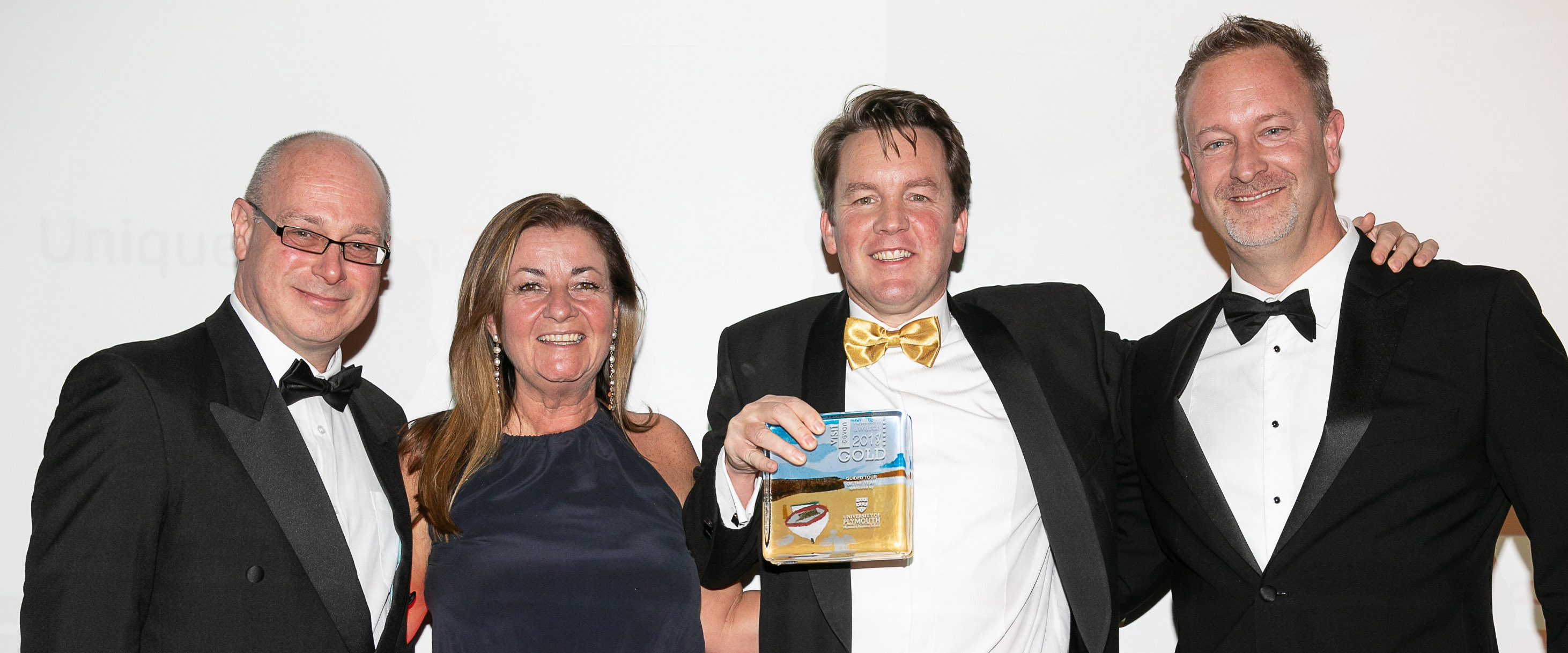 Alex and Mark collecting Gold at the Visit Devon Tourism Awards 2018