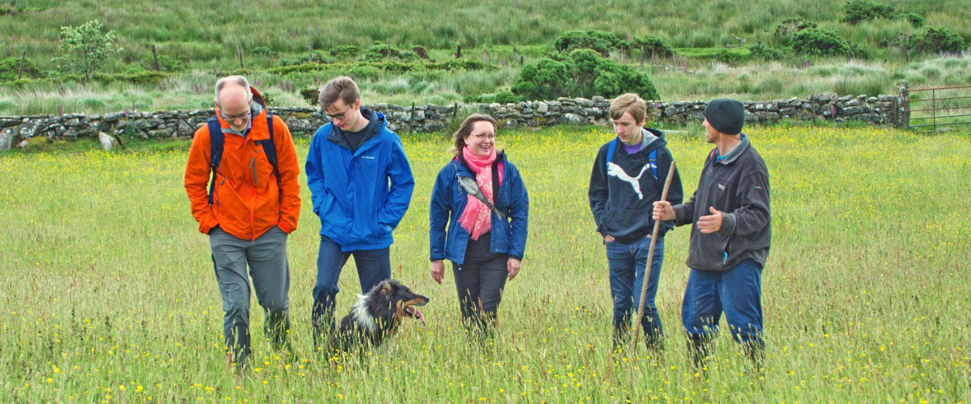 Guests walking with Ken the shepherd and his dog, Matt