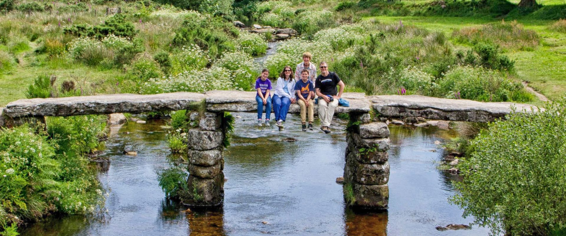 Guests on the clapper bridge at Postbridge on Dartmoor